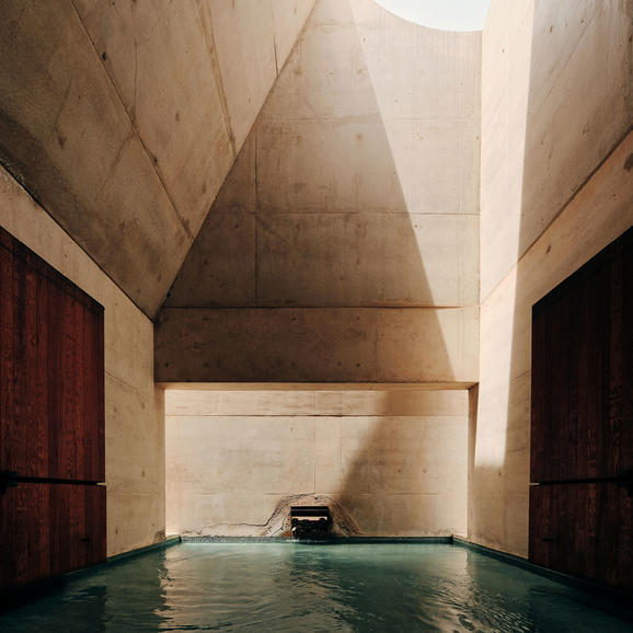 Amangiri plunge pool framed by geometric concrete walls and natural light.