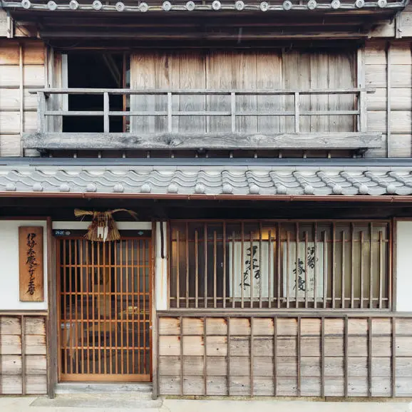 Traditional Japanese wooden façade with latticed windows and sliding doors at Amanemu.