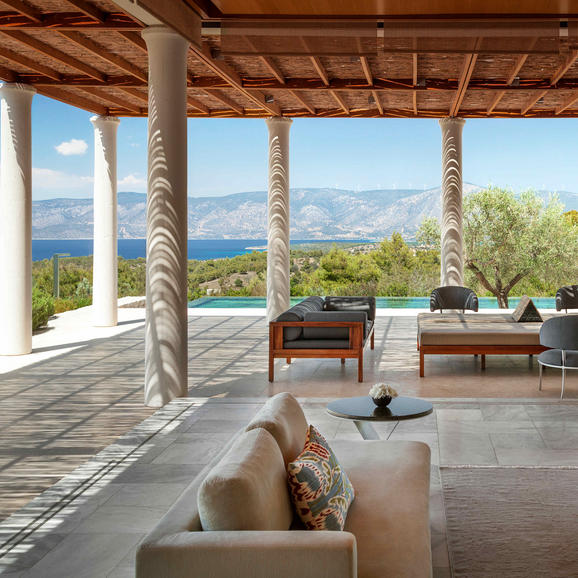 Villa terrace at Amanzoe overlooking the Aegean Sea and surrounding landscape.