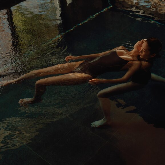 Guest floating during Watsu therapy at Amanemu's spa in Japan.