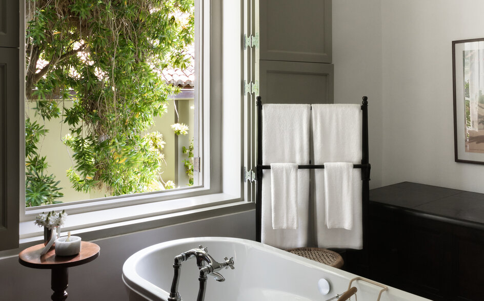 Principal bedroom bathroom at Amangalla with freestanding bath and garden views.