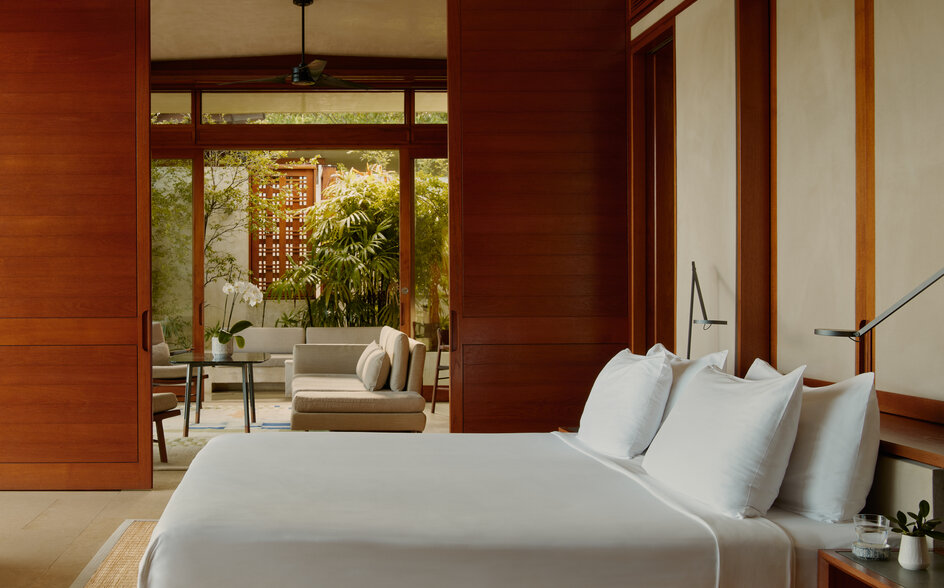 Principal bedroom in a Hill Casita at Amanera resort, Dominican Republic, with warm terracotta walls and garden views.