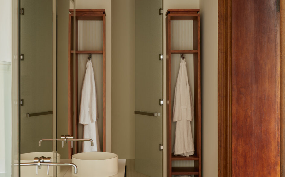 Bathroom at Aman Venice with dual vanities, mirrors and wooden accents in the Sansovino Stanza.