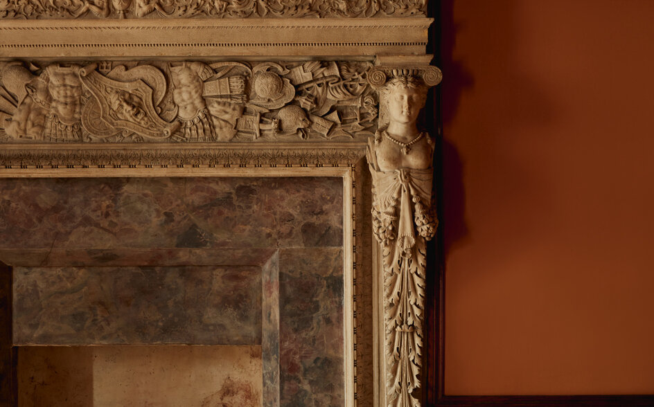 Ornate stone fireplace mantelpiece with carved classical detailing at Aman Venice.