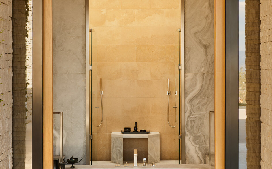 Pavilion bathroom at Amanzoe with marble walls and minimalist stone sink.