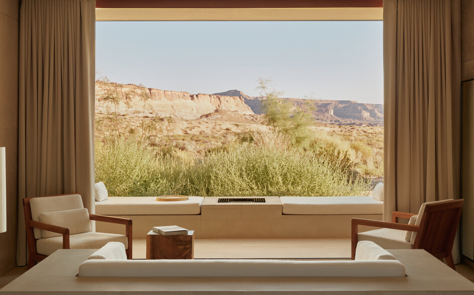 Desert suite bedroom at Amangiri with panoramic window framing canyon landscape.