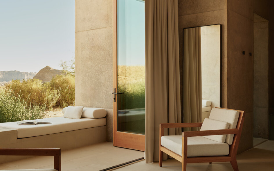 Desert Suite at Amangiri with floor-to-ceiling windows framing desert landscape and minimalist interior furnishings.