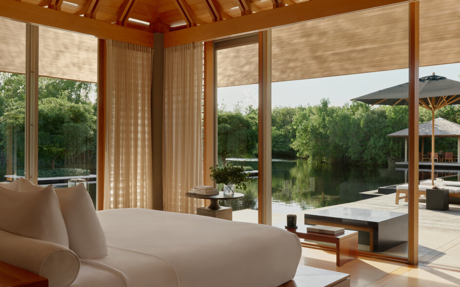 Three-bedroom villa at Amanyara with wooden ceiling, principal bedroom overlooking tropical gardens and pool terrace.