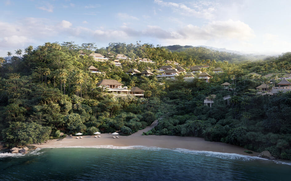 Amankila residence nestled on a verdant hillside overlooking a turquoise coastal cove in Indonesia.