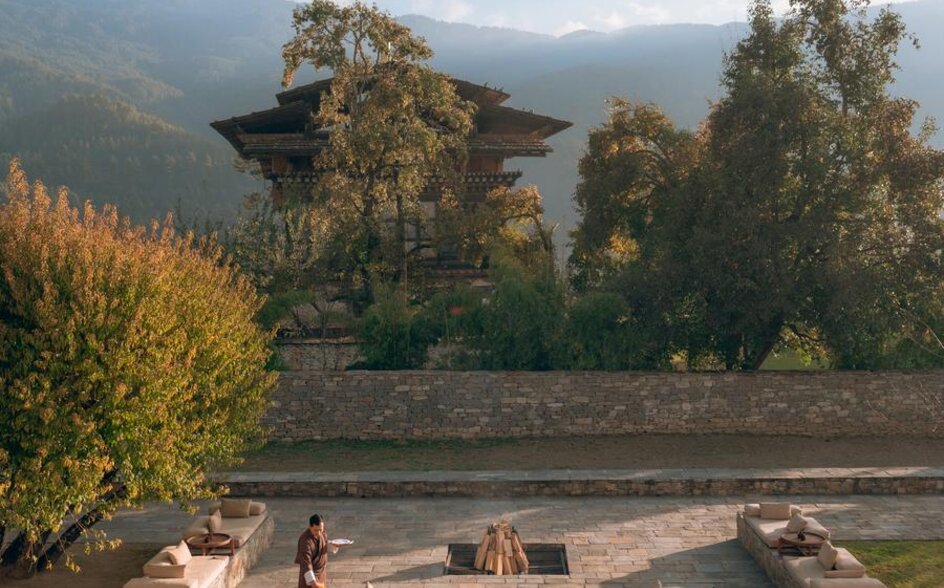 Firepit seating area at Amankora's Bumthang Lodge with mountain and valley views.