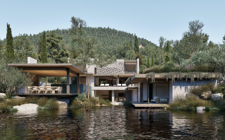 Waterfront pavilions and wooden structures at Aman Residences Bodrum, reflected in the calm lagoon waters.