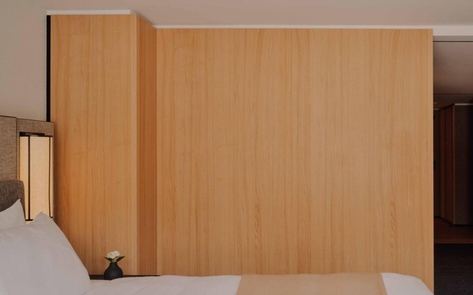 Superior room at Aman Rosa Alpina with wooden wardrobe and bed detail, Italy.