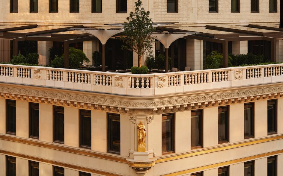 Aman New York's Crown Building exterior featuring neoclassical architecture with arched colonnade and cream-coloured facade.