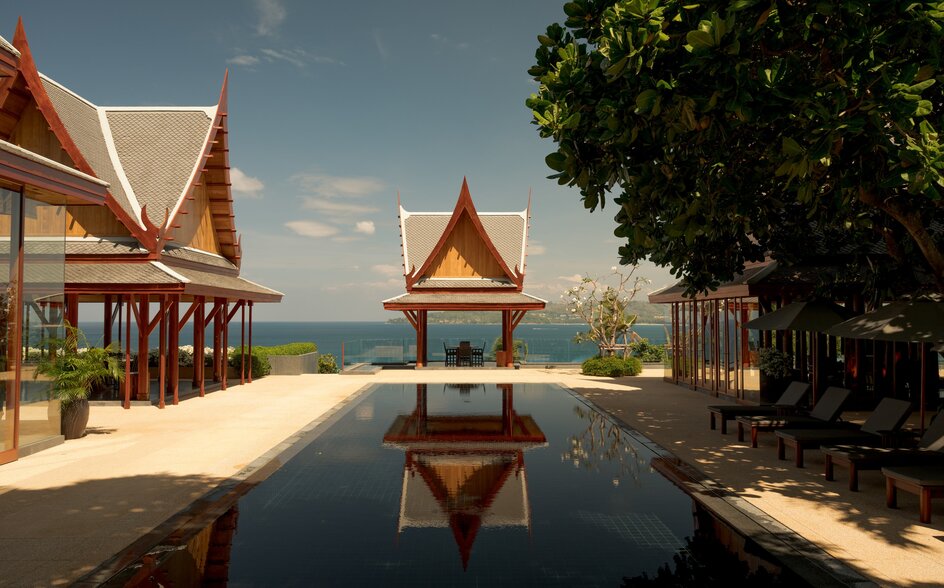 Seven-bedroom ocean villa with infinity pool reflecting Thai architecture at Amanpuri, Thailand.