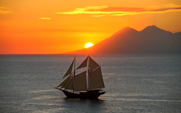 Traditional sailing vessel at sunset in the Spice Islands, Amandira.