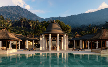 Amanjiwo's poolside pavilions and dining terrace with forested mountain backdrop at sunset.