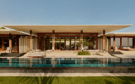 Amanera accommodation villa with infinity pool overlooking tropical gardens at dusk.