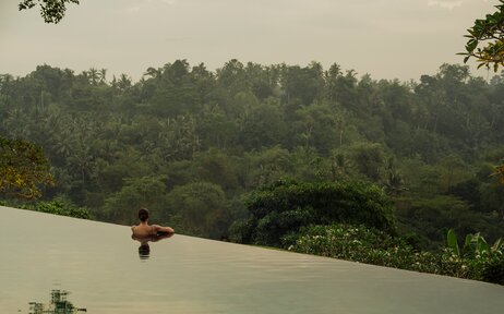 Infinity pool overlooking dense forest at Amandari, Bali.