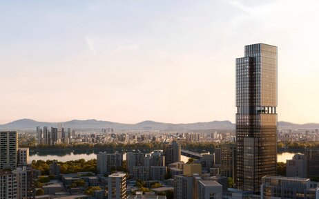 Aman Seoul rises above the city skyline at dusk, with mountains visible in the distance.