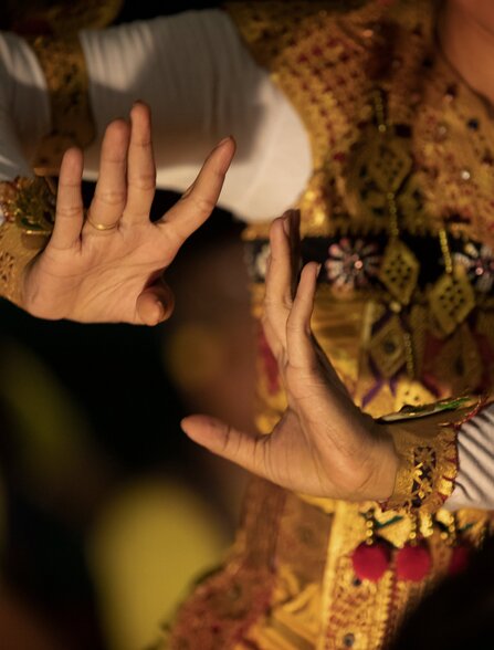 Dancer's hands adorned with traditional Balinese makeup during a performance at Amankila, Indonesia.