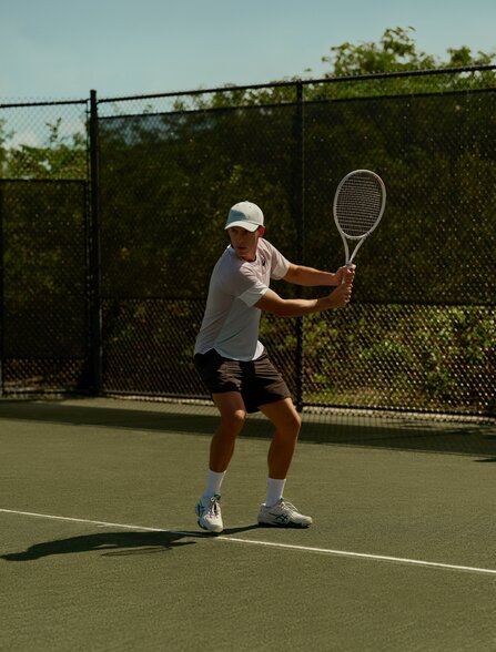 Guest playing tennis at Amanyara's court in Turks and Caicos.