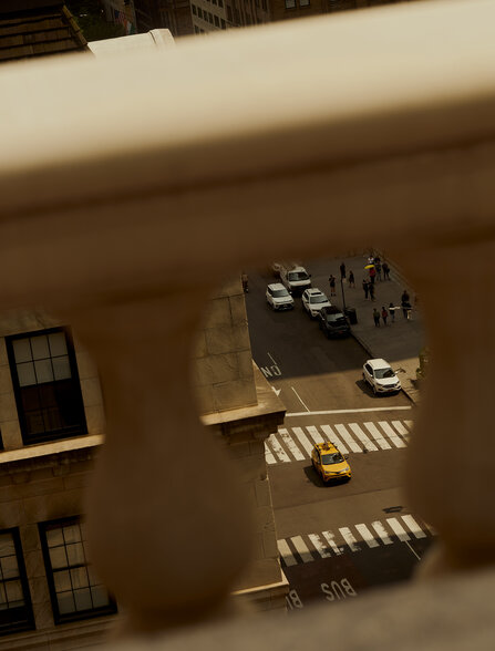 Overhead view of a New York courtyard at Aman New York, showing building facades and window arrangements.