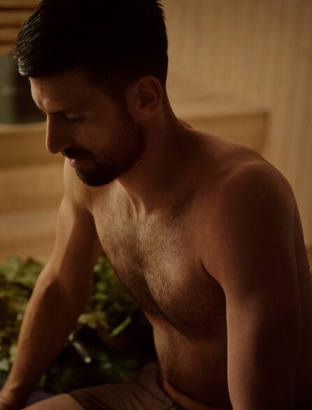 Novak Djokovic at Amanpuri, Thailand, seated beside a plunge pool in evening light.