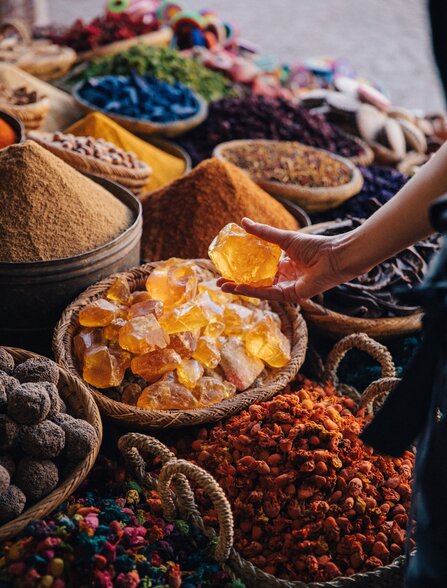 Colourful spices and dried goods displayed in bowls and vessels at Amanjena.