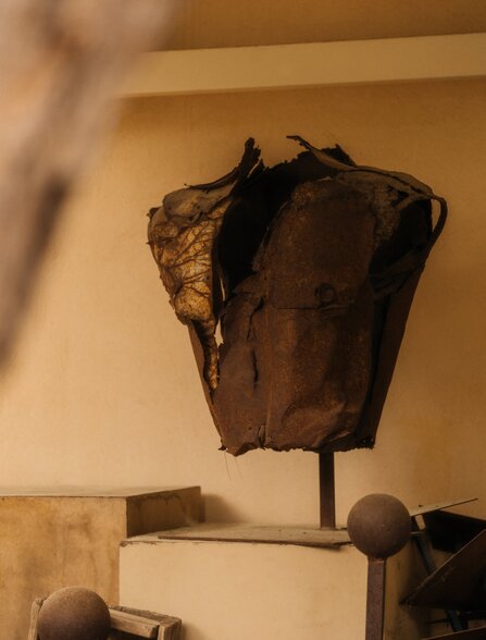 Studio portrait of a textured bronze fabric sculpture on display at Amanzoe, Greece.