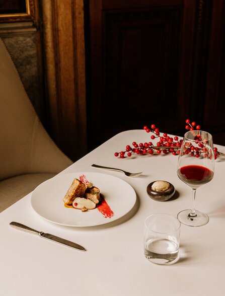 Guinea fowl dish at Arva Restaurant, Aman Venice, with red berries and wine.