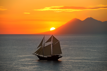 Traditional sailing vessel at sunset in the Spice Islands, Amandira.
