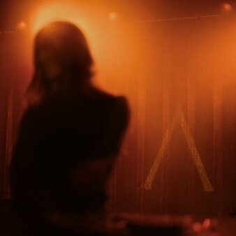 Silhouetted figure at The Jazz Club, Aman New York, during a band and DJ performance.