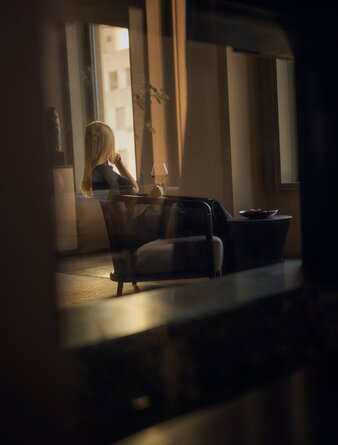 Sunlit suite at Aman New York with floor-to-ceiling windows and an inviting seating area.