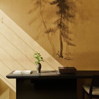 Minimalist desk at Aman New York with single flower stem and shadow cast on warm ochre wall.