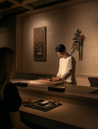 Woman viewing artwork in gallery at Aman New York, USA.