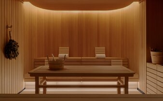 Wooden spa treatment room at Aman New York with warm lighting and minimalist furnishings.