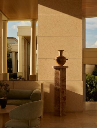 Amanzoe resort interior with stone sculpture and warm architectural lighting.