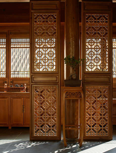 Carved wooden doors with geometric lattice panels at Amandayan.