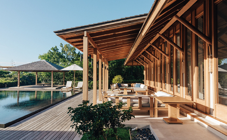Wooden pavilion with covered terrace overlooking plunge pool at Amanyara, surrounded by tropical gardens.