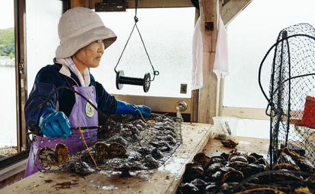 Woman sorting seaweed at Amanemu resort in Japan.