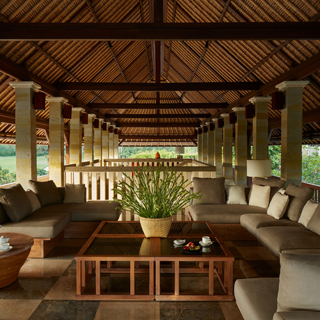 Six-bedroom villa living pavilion at Aman Villas at Nusa Dua, Bali, with wooden beams and stone seating.