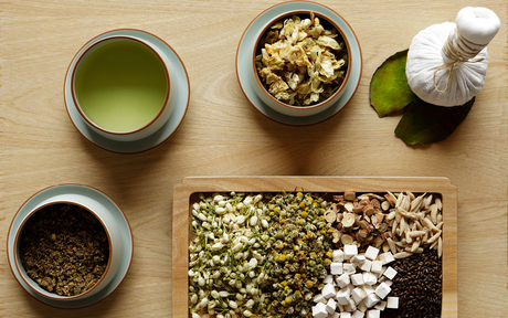 Amanyangyun tea ceremony arrangement with matcha, whisks, and traditional vessels on wooden surface.