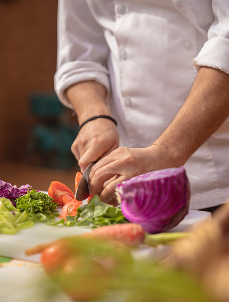 Chef's hands slicing purple cabbage at Aman Villas at Nusa Dua.