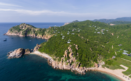 Amanoi's clifftop setting overlooking a turquoise bay and forested Vietnamese coastline.