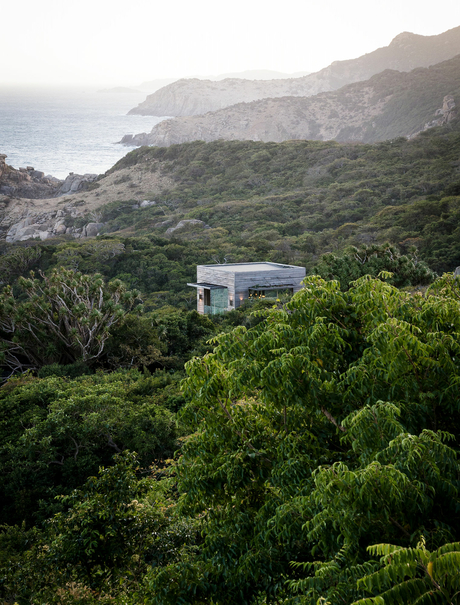 Modern pavilion nestled amongst dense forest and coastal cliffs at Amanoi.