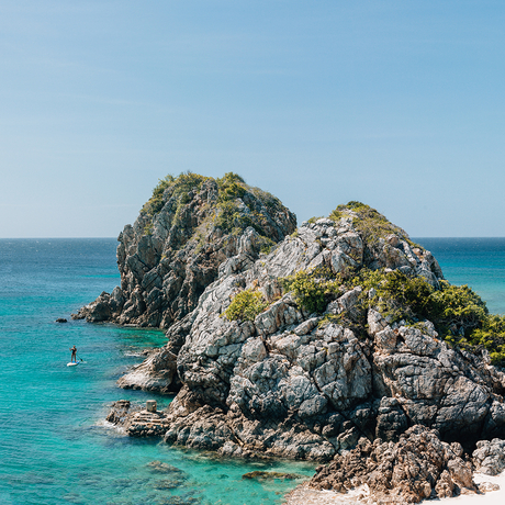 Rocky islet with turquoise waters at Amanpulo, Philippines.