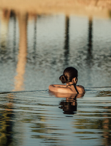 Guest swimming in a cenote at Amanvari, Mexico.