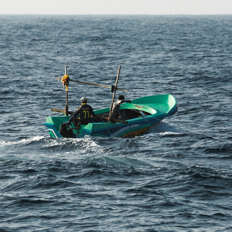 Traditional fishing boat on calm waters at Amanwella.