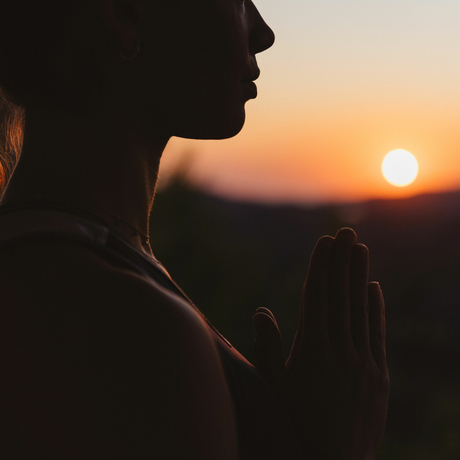 Silhouette of a woman in profile at sunset, Amanzoe resort.