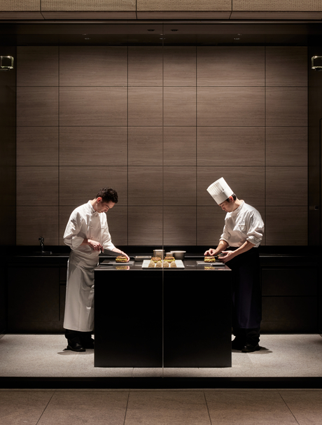 Two pastry chefs prepare delicate creations at Aman Tokyo's La Pâtisserie kitchen.